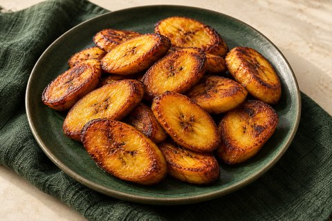 Golden fried ripe plantain slices with dark caramelized patches